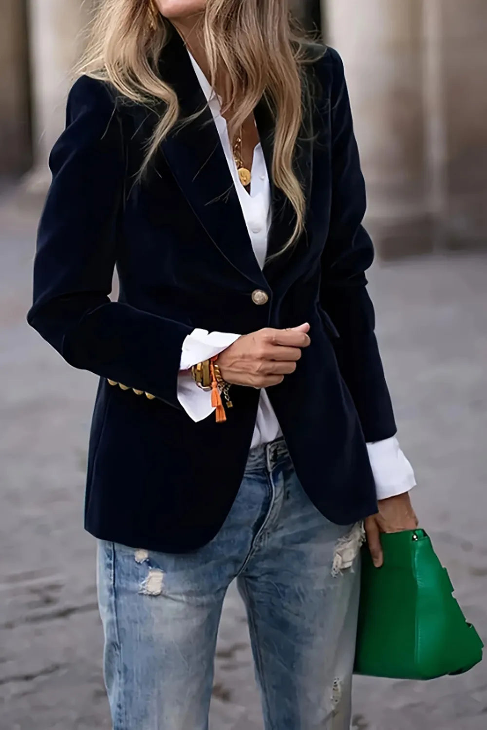 Women’s one button lapel collar long sleeve blazer in navy blue with gold buttons, paired with white shirt and blue jeans